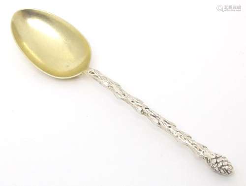 A Victorian silver teaspoon with foliate cast handle with st...