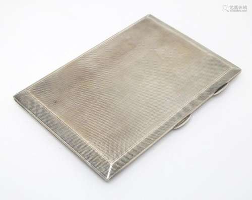 An Art Deco silver cigarette case with engine turned decorat...