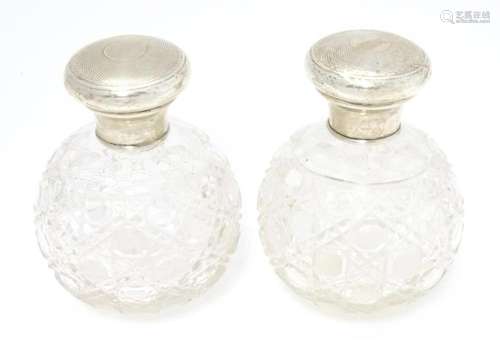 A pair of early 20thC cut glass scent / perfume bottles with...