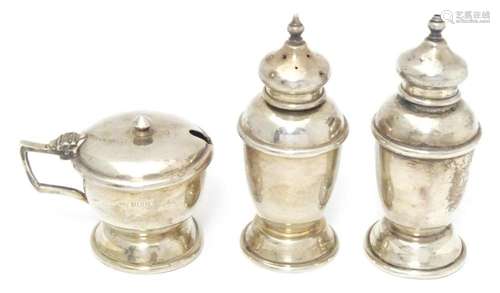 A silver three piece cruet comprising salt and pepper pots a...