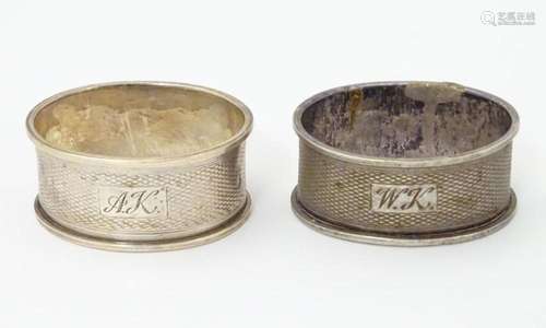 A pair of silver napkin rings with engine turned decoration,...