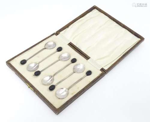 A cased set of six coffee spoons with coffee bean decoration...