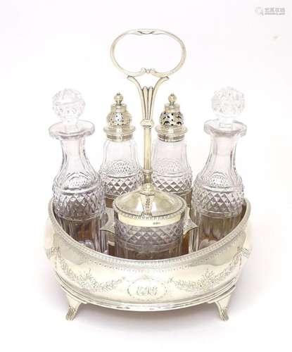 A Geo III silver cruet stand, with five associated cut glass...