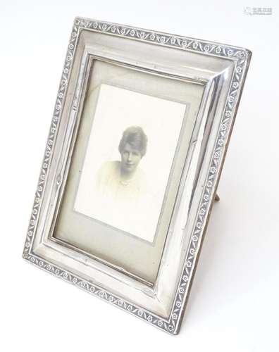 An easel back photograph frame with silver surround hallmark...