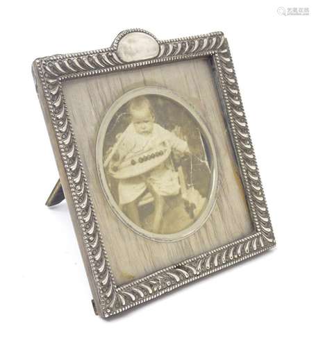 An easel back photograph frame with a silver surround hallma...