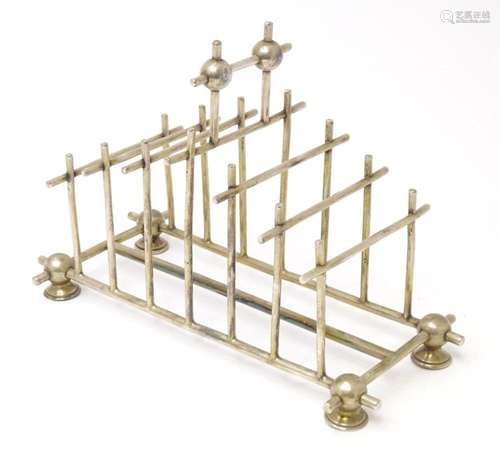 A silver plate 7 bar toast rack in the manner of Christopher...