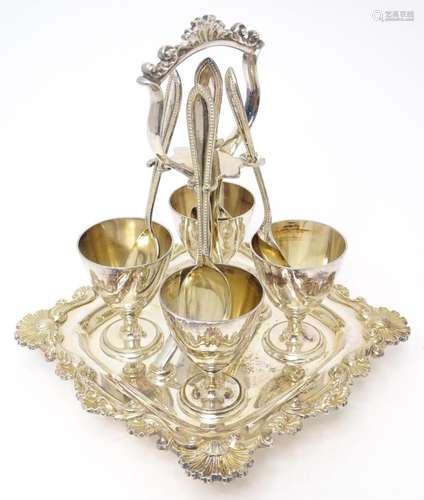 A silver plate egg cruet with four pedestal egg cups etc . 7...