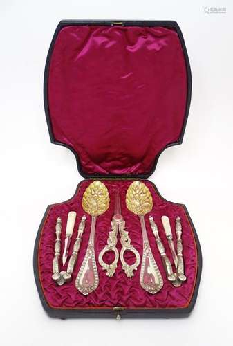 A cased silver plated set comprising berry spoons, grape she...