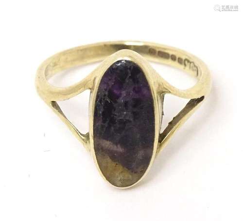 A 9ct gold ring set with a blue john cabochon. Ring size app...