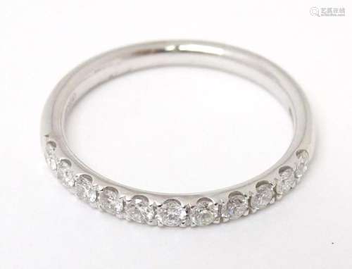 A platinum half eternity ring set with band of diamonds. rin...