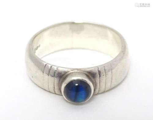 A silver ring set with blue stone cabochon. Maker RSS. Ring ...