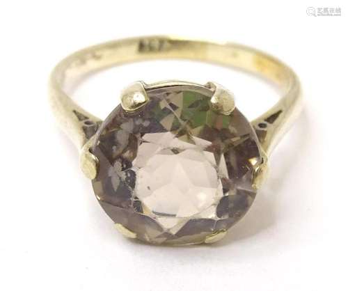 A 9ct gold ring set with smoky quartz. Ring size approx K