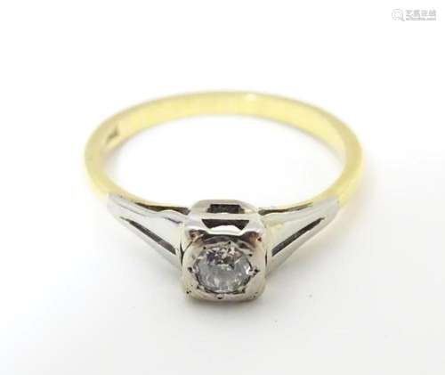 An 18ct gold diamond solitaire ring in a square setting. Rin...