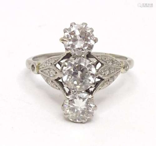 An impressive Art deco diamond ring set with trio of diamond...