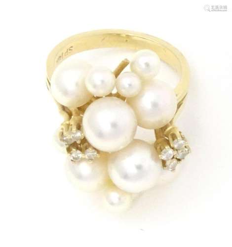 A 14ct gold ring set with cluster of pearls and diamonds . R...