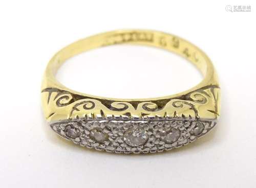 A 9ct gold ring set with 5 platinum set diamonds. Ring size ...