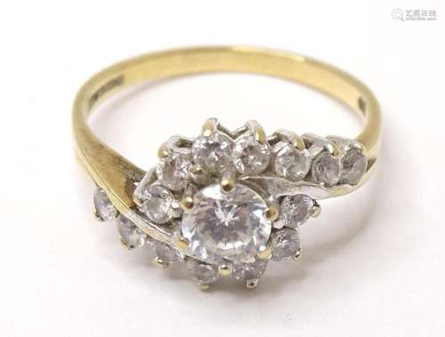 A 9ct gold ring set with a cluster of cubic zirconia. Ring s...