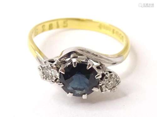 An 18ct gold and platinum ring set with central sapphire fla...