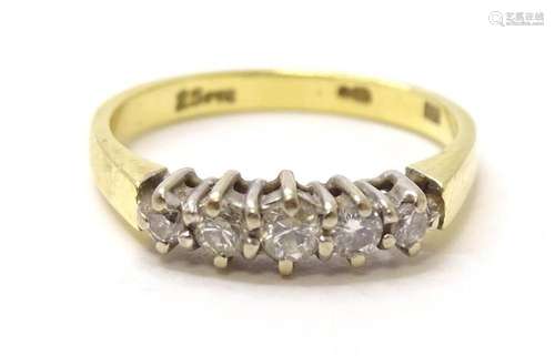 An 18ct gold ring set with 5 diamonds. ring size approx. I