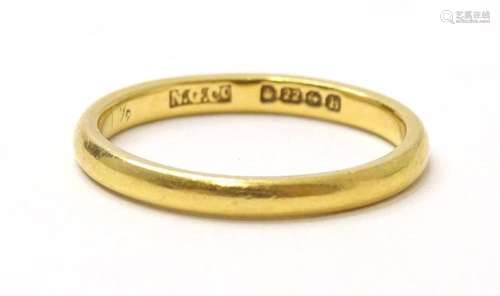 A 22ct gold band. The ring size approx G 1/2