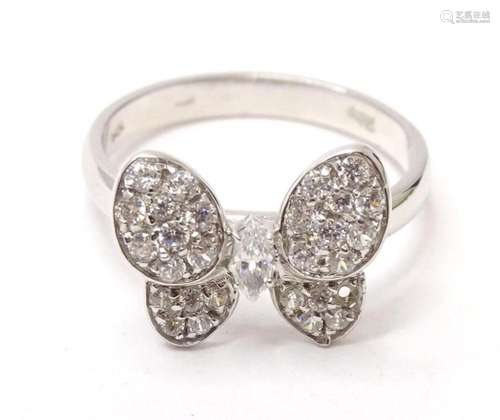 A white metal dress ring marked 14k with white stones in a b...