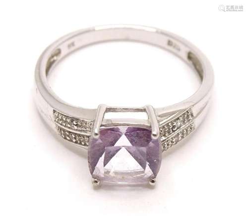 A 9ct white gold ring set with central amethyst flanked by c...