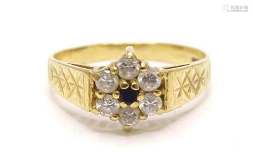 A 9ct gold floral cluster ring set with blue and white stone...