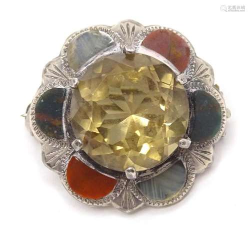 A Scottish silver brooch set with central citrine bordered b...