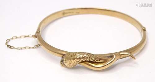 A 9ct gold bracelet / bangle with snake / serpent detail.