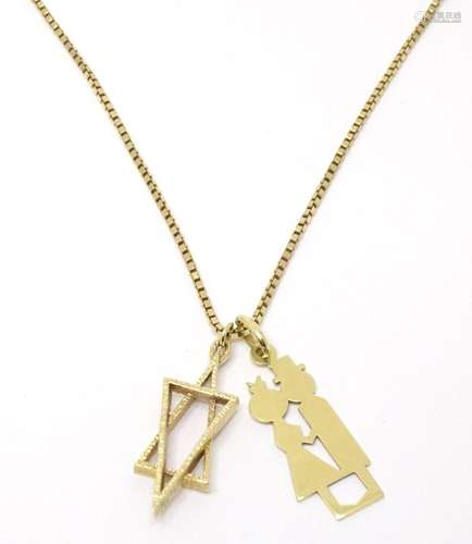 A 9ct gold chain necklace with 9ct gold pendant formed as th...