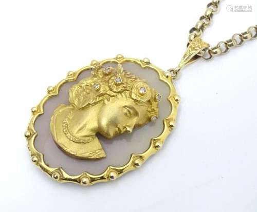 A 9ct gold chalcedony and diamond pendant of cameo style wit...