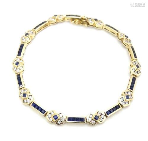 A 14ct gold bracelet set with white stones and blue sapphire...