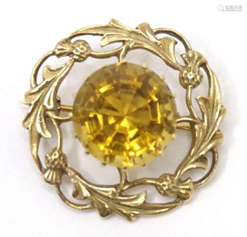 A Scottish 9ct gold brooch with thistle detail set with cent...