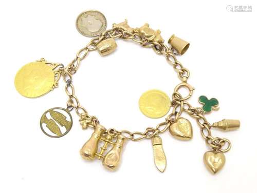 A gold charm bracelet set with various gold, yellow metal an...