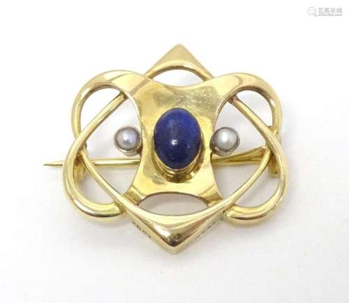 A 15ct gold Art nouveau brooch set with central blue cabocho...