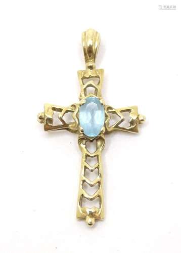 A gold cross pendant set with topaz coloured blue stone. 1&q...