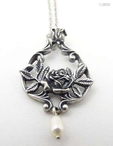 A Sterling silver pendant on a chain, the pendant with centr...