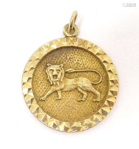 A 9ct gold pendant with lion decoration to centre. Approx. 3...