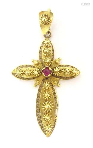 An 18ct gold pendant of cross form set with central red ston...