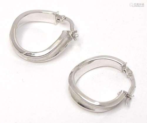 A pair of 9ct white gold hoop earrings. Approx. 3/4" lo...