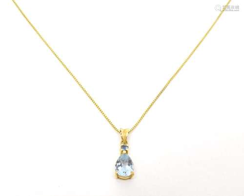 A 9ct gold necklace with aquamarine pendant. the chain The p...