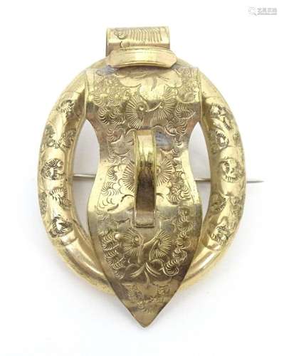 A Victorian gilt metal brooch of buckle form with engraved f...