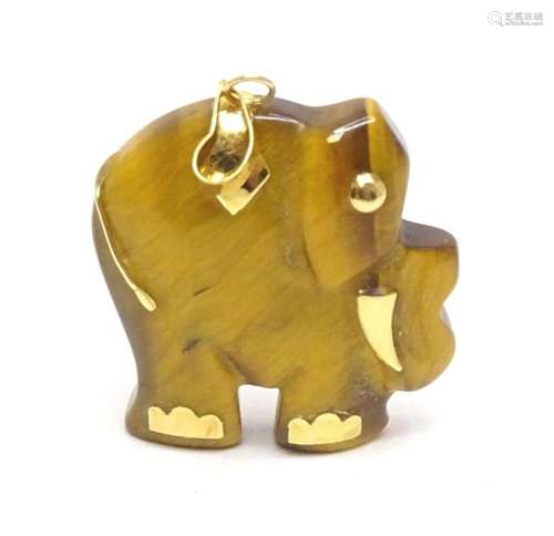 A tigers eye pendant modelled as an elephant with 9ct gold m...