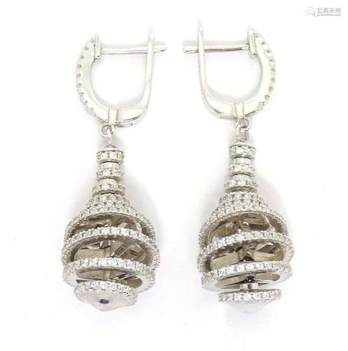 A pair of white metal drop earrings set with white stones 1 ...