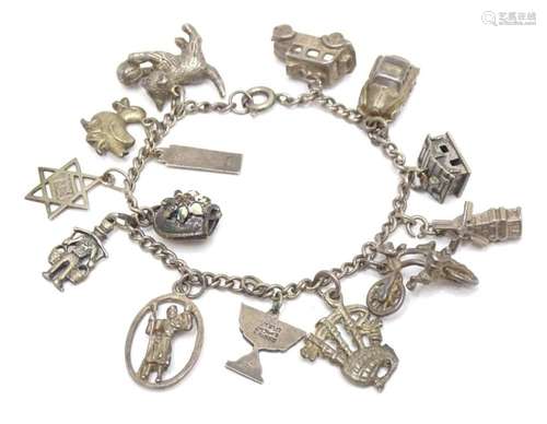 A white metal charm bracelet with assorted charms