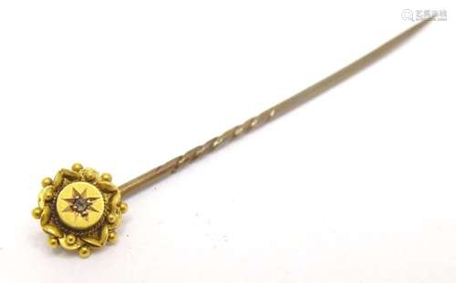 A 15ct gold stick pin set with diamond, approx 2" long.