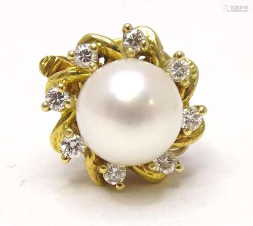 A gold clasp set with central pearl bordered by diamonds App...