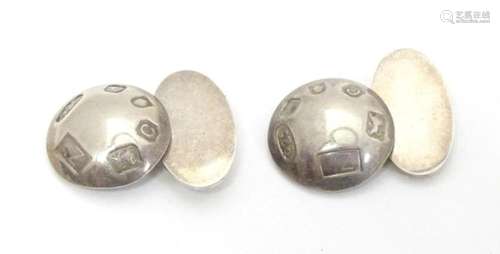 A pair of silver cufflinks with hallmark decoration