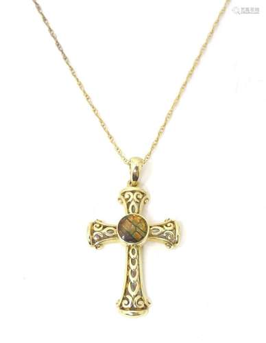 A 9ct gold pendant and chain, the pendant of cross form and ...