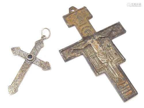 A crucifix pendant together with a white metal cross pendant...